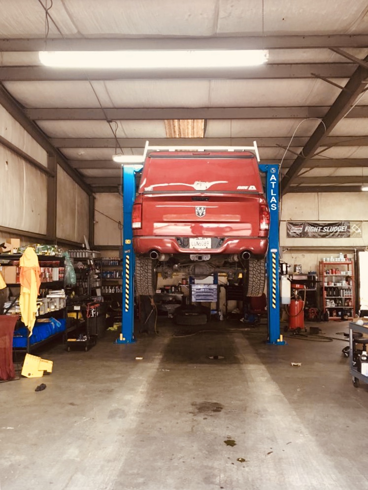A truck up on the lift in the J&T Truck and Auto Service bay in Stockbridge, GA